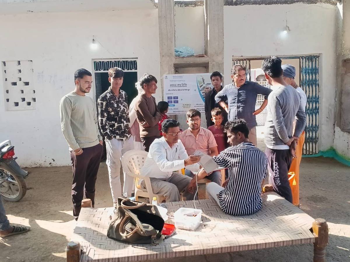 Blood pressure check-up at outdoor community health camp