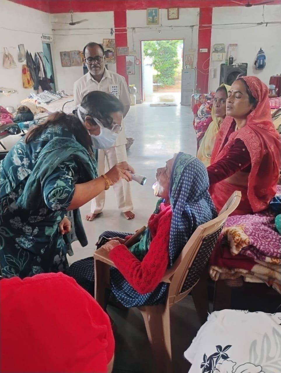 Dental check-up for senior citizen at a health camp